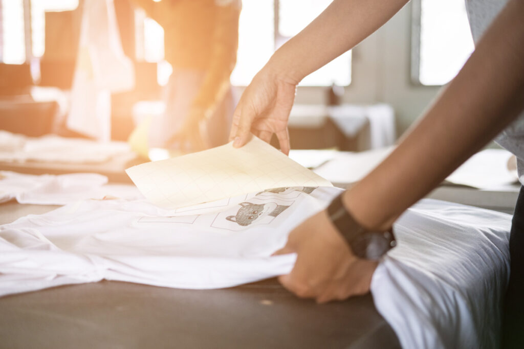 Man creating a custom t-shirt using screen printing in El Paso.